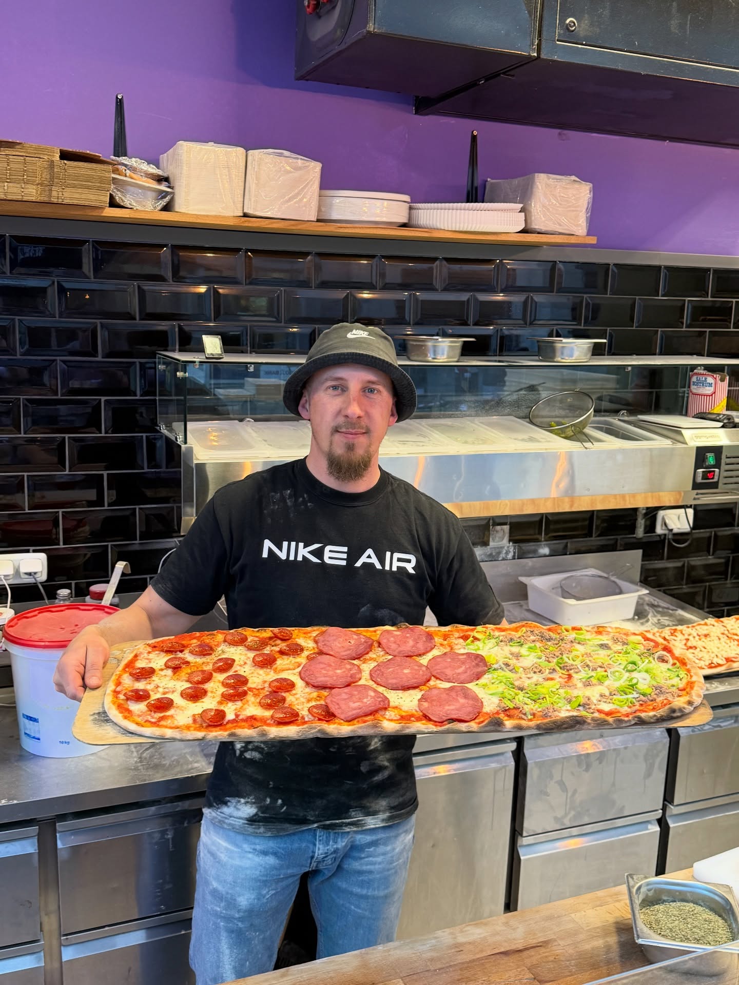 Henry, Gründer von Henry's Meterpizza Kassel, mit einer frischen Meterpizza